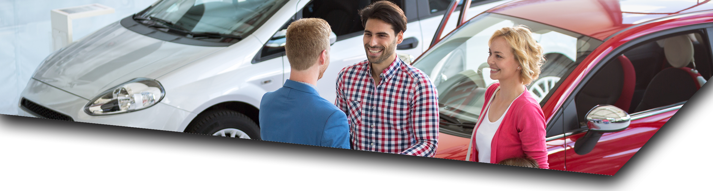 Husband and wife talking to a car salesman about competitive auto loan rates