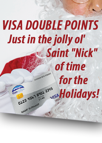 Jolly Old St. Nick holding a UHCU credit card.